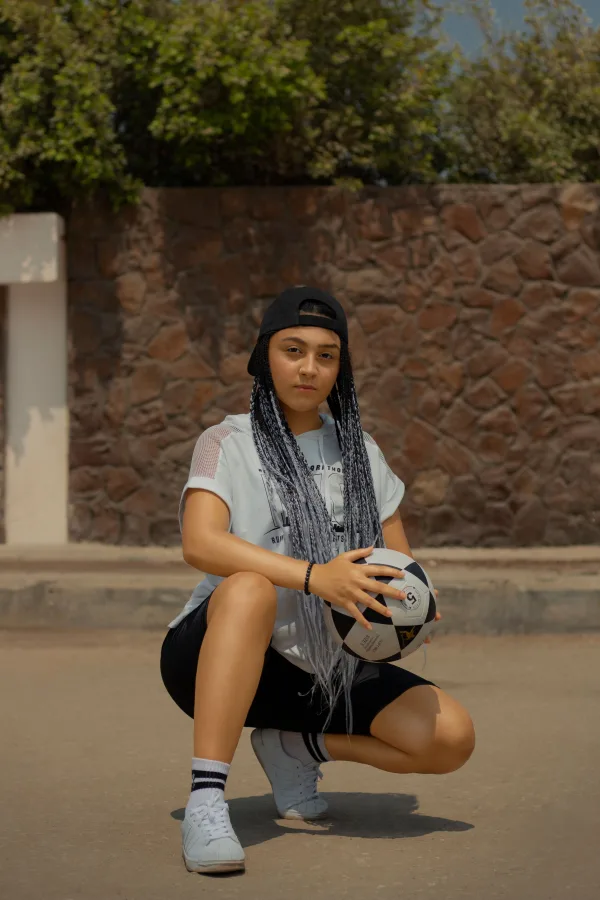 Jeune sportive avec ballon lors d’un entraînement en extérieur