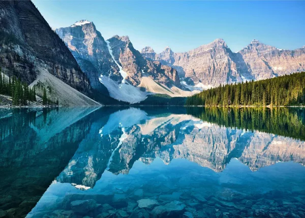 Lac de montagne miroir avec reflet parfait des sommets enneigés